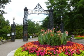 The Halifax Public Garden gates with a bright flower bed in the foreground