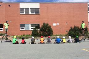children sit beside skateboards at recreation facility in Sackville 