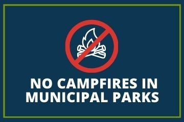 An icon of a campfire in a red crossed-out circle on a blue background with the caption, "No campfires in Municipal parks".