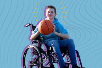 A youth in a wheelchair is holding a basketball