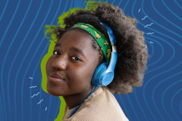 A youth looks at you while wearing headphones