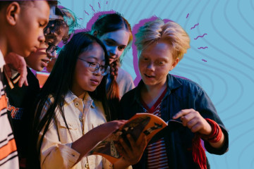 A group of youth looking at a cell phone