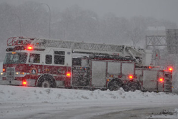 A firetruck in a snow storm. 