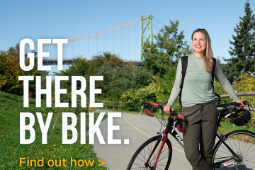 Young woman leaning on a bicycle on the Barrington Greenway near the MacDonald Bridge