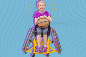 A youth in a sport chair, holding a basketball