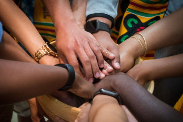 Different peoples' hands held together